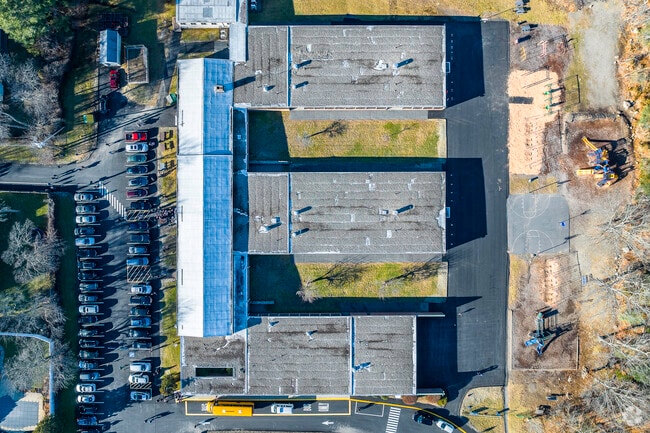 An aerial top-down view of John P. Oldham Elementary School in Norwood, MA.