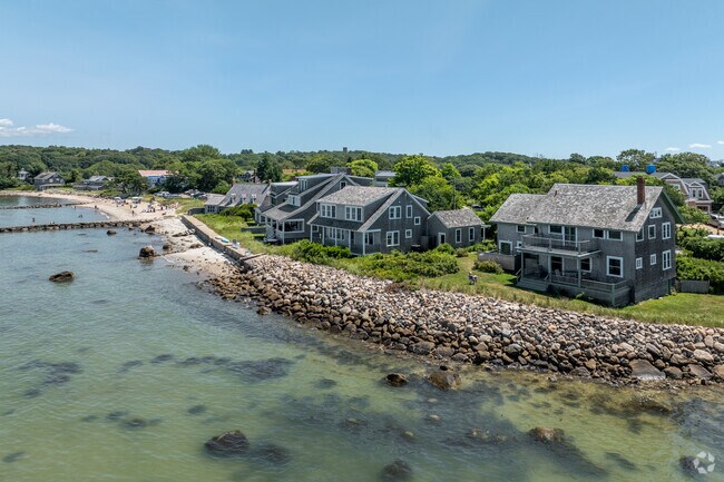 Seaside homes hug the nearby beach of Woods Hole.