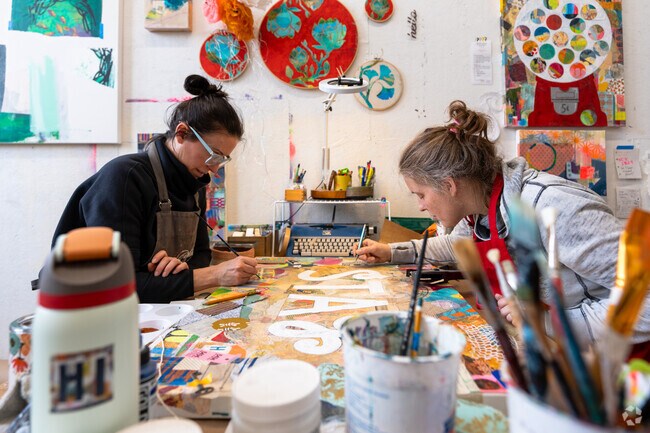 Artists at BNA Makery in Saxonville work on a new piece of artwork.