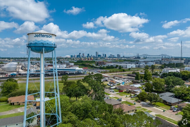 The Jefferson Parish water tower looks over the Harvey neighborhood, with New Orleans skyline.