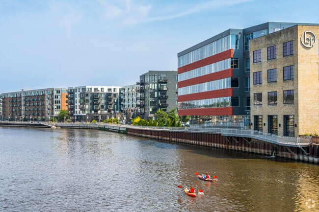 Kayaks make their way down the Milwaukee river near Halyard Park.
