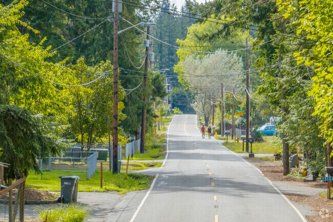 Locals walk the forest covered Erlands Point Road in Erlands Point WA.
