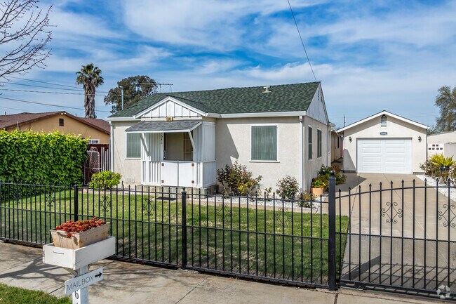 This cute Bungalow home has a small garage in back and gated yard in Ben Ali.