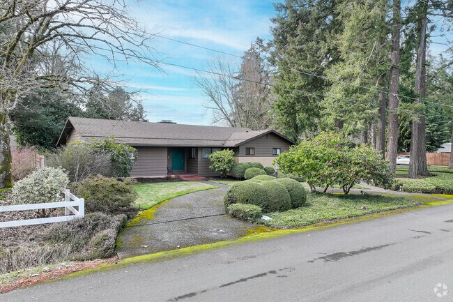 A brown ranch style home is sheathed in character in Cooper Mountain - Aloha South.