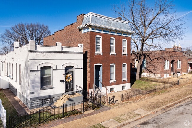 Large brick 2 story Italianate homes line a neighborhood street in Patch.