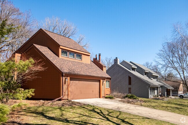 Various angular, contemporary houses are located on a secluded street.