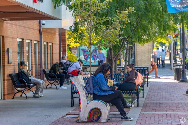 Artful benches in Downtown State College resemble folded books, near Highlands.