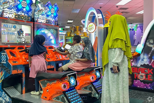 Children love playing arcade games at Chuck E. Cheese located in Consumer Square West Center.