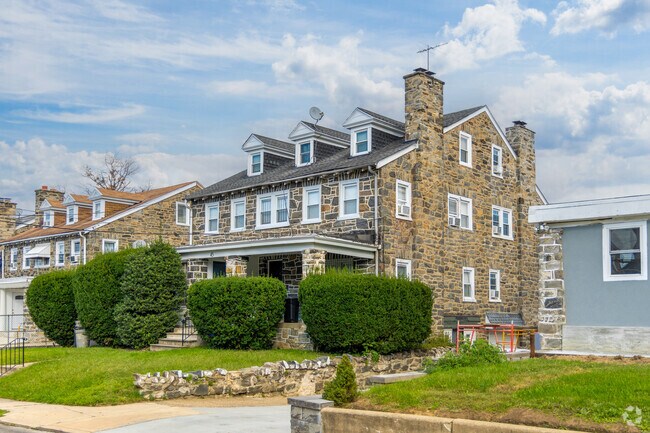 A stone Cape Cod with beautiful landscaping in Stonehurst.