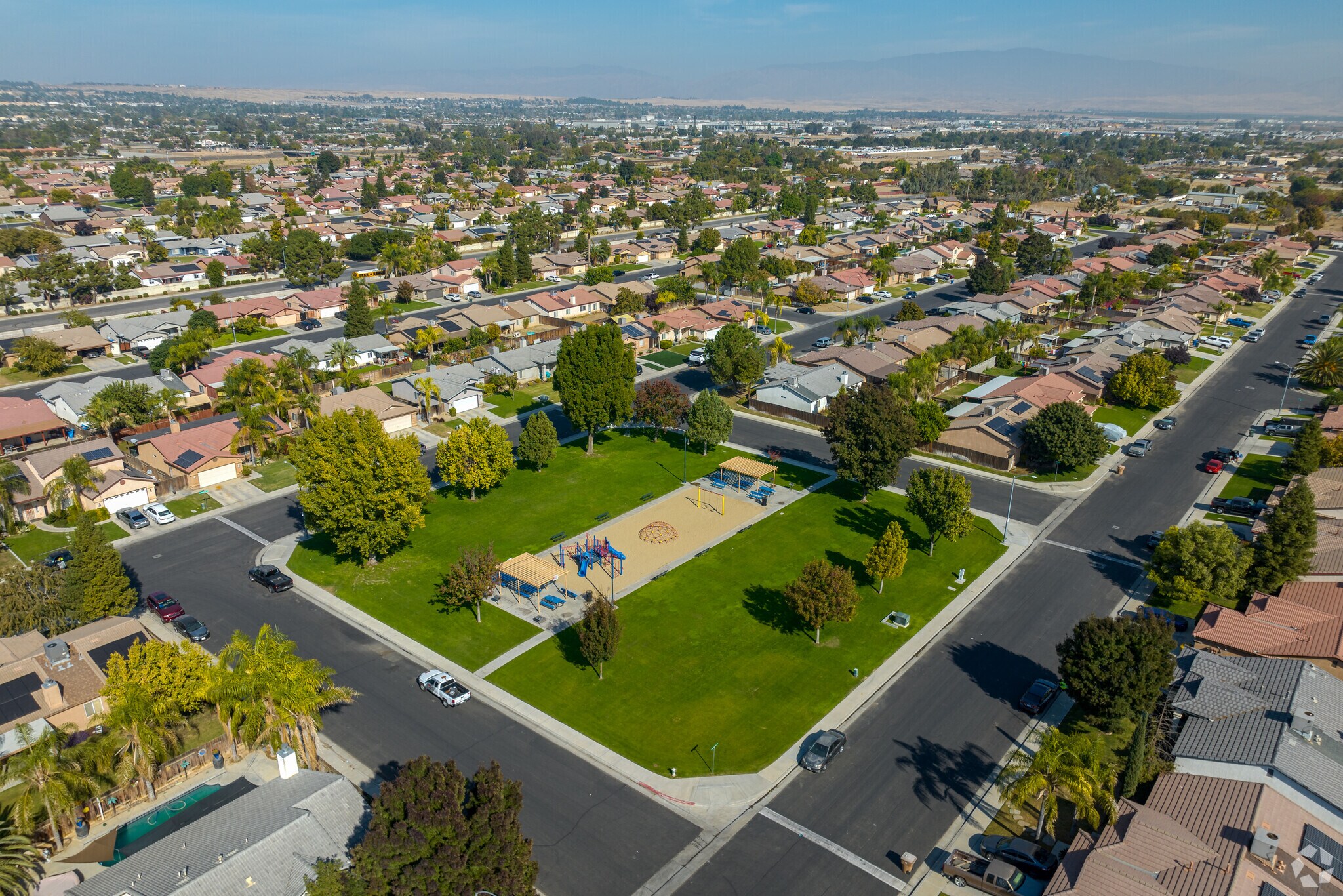 Tyner park features a sandy playground surrounded by an open grassy area.