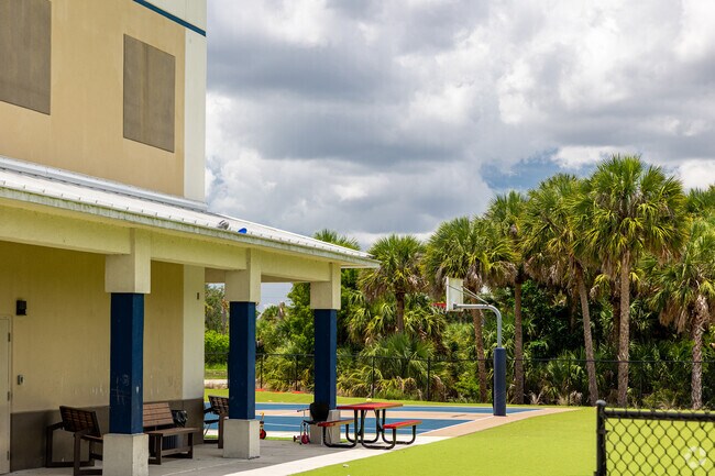 Collier Charter Academy in Naples features an outdoor basketball court and seating areas .