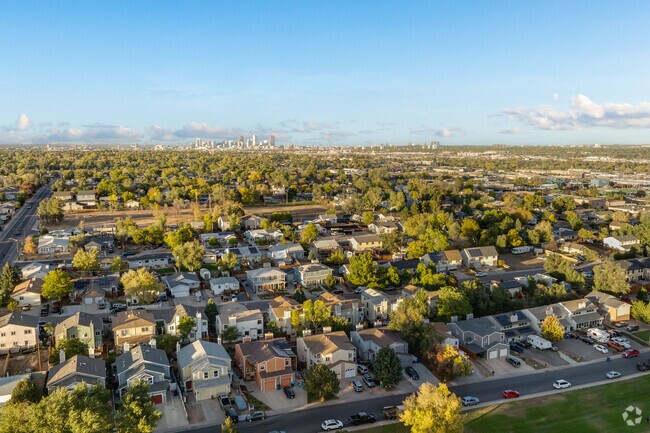 A view from above the calm neighborhood of Baker Park with Downtown Denver in the distance.