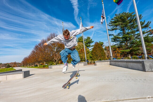 A UMass student enjoys his  time between classes by skateboarding on the outskirts of campus.