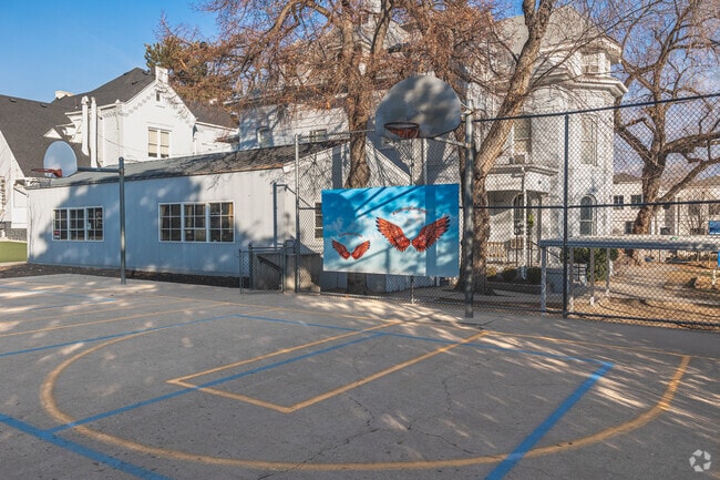 Selfie angel wings sit behind a basketball court at The Madeleine Choir School.