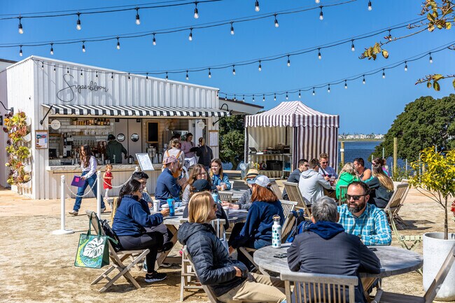 Superbloom Cafe patrons enjoying the courtyard with view of Mission Bay near Bay Park.