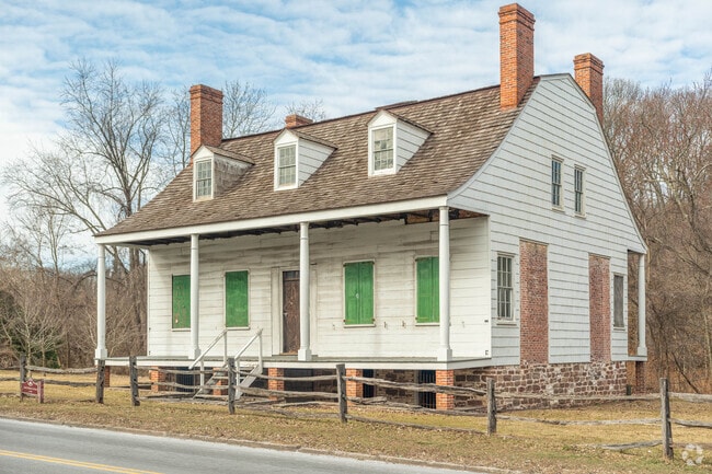 A historic Building in Richmond Town features charming bright green shutters.