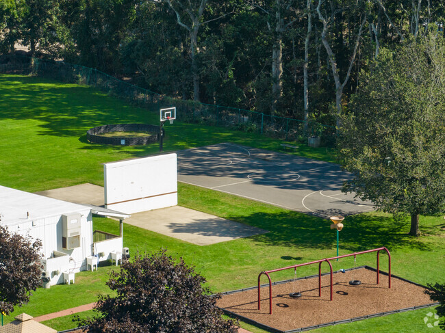 Tuckahoe School has a playground and basketball court on the side of the school.