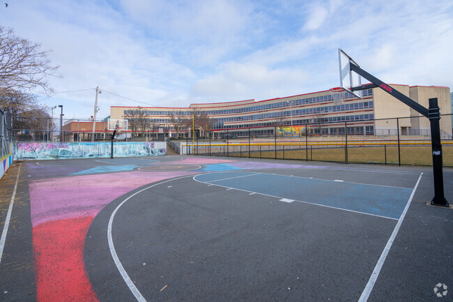 Shoot hoops on the basketball court in front of the Garfield Elementary School.