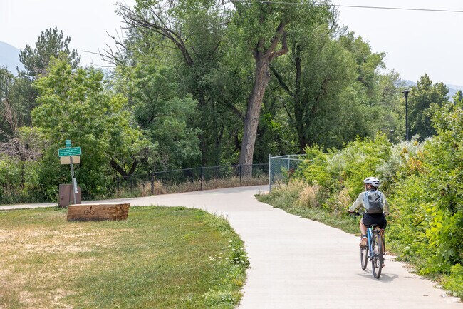 A woman rides her bike along one of the many biker thoroughfares in Central Boulder.