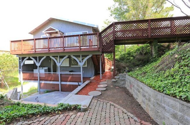View of the side of the house, the lower deck and patio