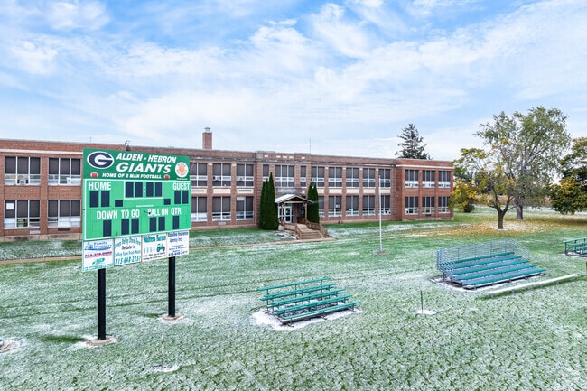 Alden Hebron High School has a football field adjacent to the school building.