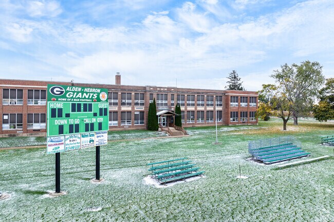 Alden Hebron High School has a football field adjacent to the school building.
