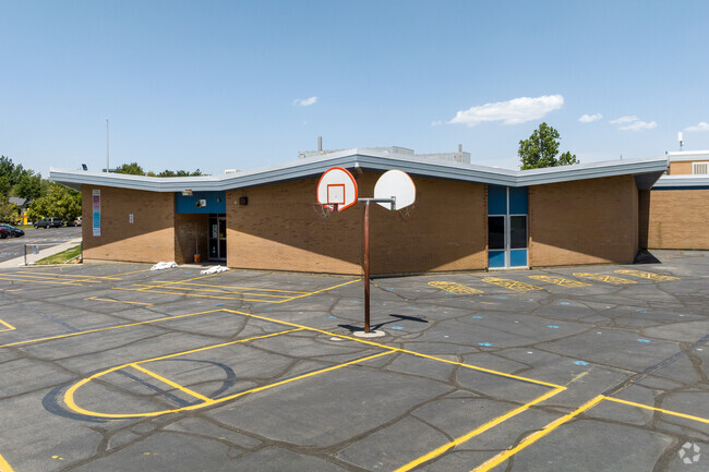 Basketball courts in front of a zig zag roof at Parkside Elementary School.
