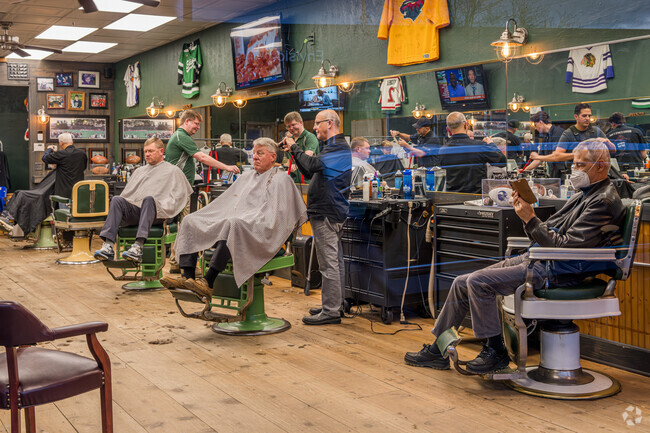 Customers getting haircuts at Dick's Sports Barbers in the Morningside neighborhood.