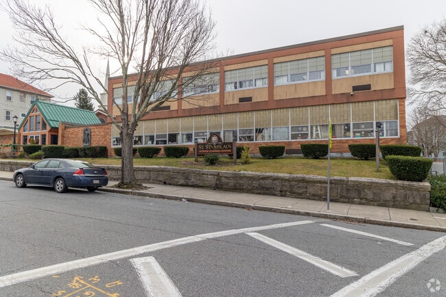 A closer look at the front right side of Saint Stanislaus School in Fall River, Massachusetts.