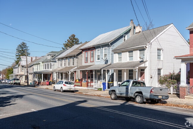 Colonial homes mixed with similar duplexes line Penn St in Heidelberg.