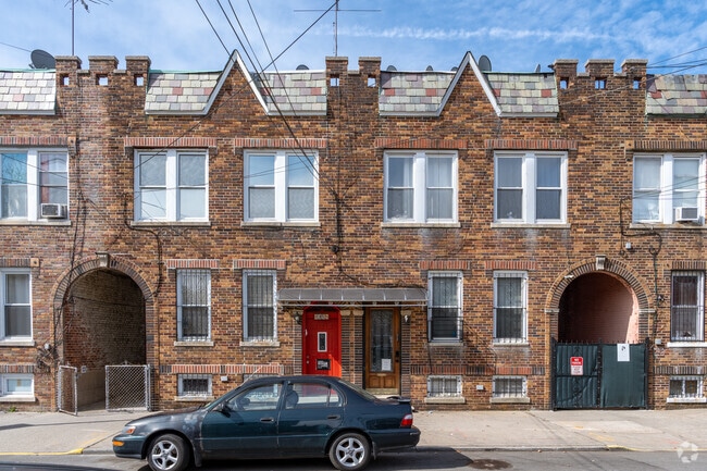Semi-detached brick homes, with private parking around back in East Elmhurst.