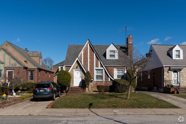 Utopia's enchanting Tudor style home: A timeless architectural gem in the neighborhood.