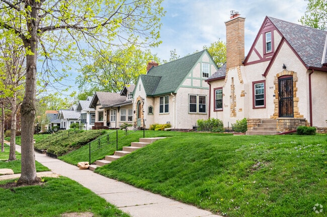 A row of homes in the Audubon Park neighborhood with a couple tudors in the foreground.