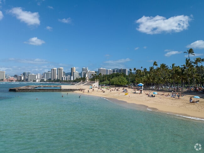 Tourists and locals flock to Kaimana Beach for swimming and sunbathing in Kapahulu, Honolulu.