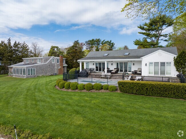 Ranch homes with cross-gabled roofs overlook the bay in Nassau Point.