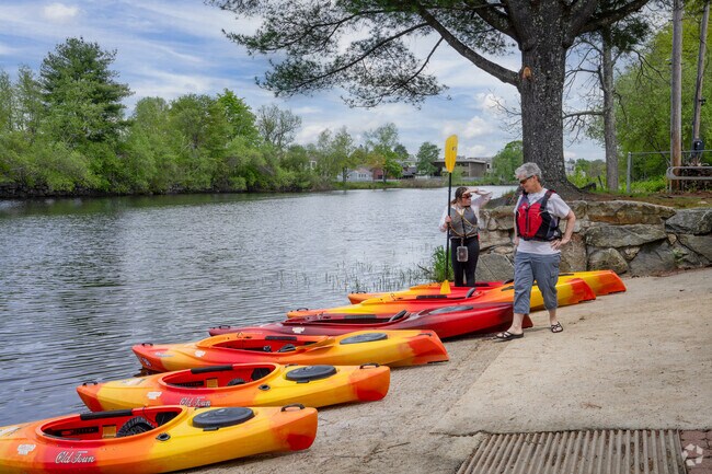 Kayakers prepare to hit the water on the Miller River in Orange.