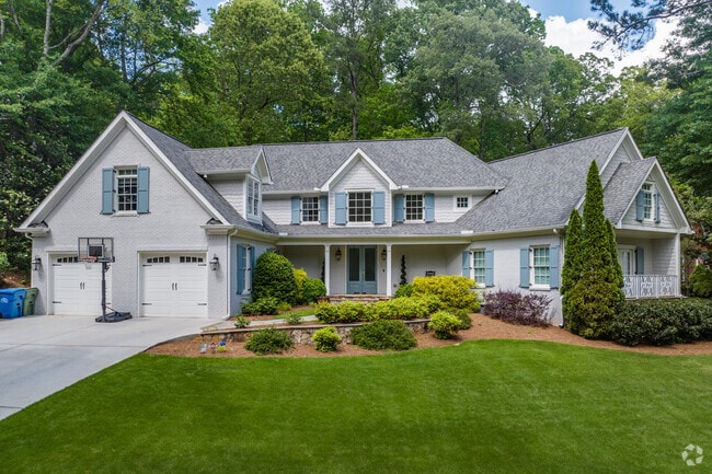 Large traditional homes with manicured lawns and broad driveways emphasize the neighborhood's upscale, yet inviting character.