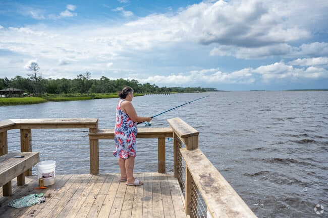Fishing from the dock along the Cape Fear River offers a peaceful and scenic pastime for residents near The Cape.