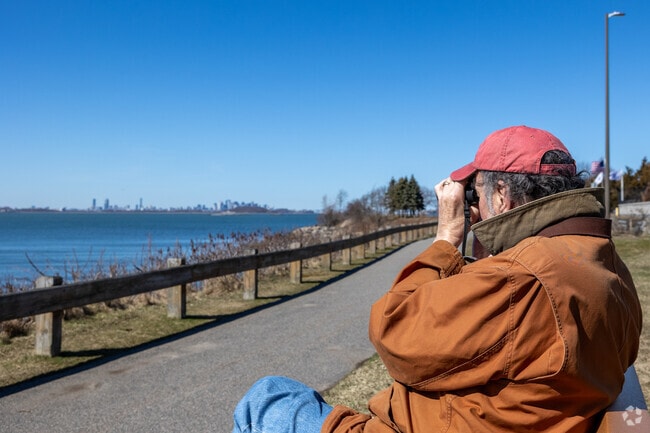 Folks take in the city sights over the water at Nut Island in Houghs Neck.