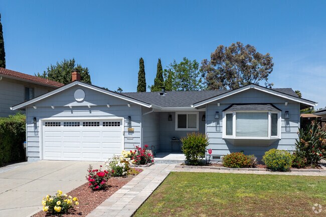 A charming ranch-style home in Morrill features a bay window and fresh landscaping.