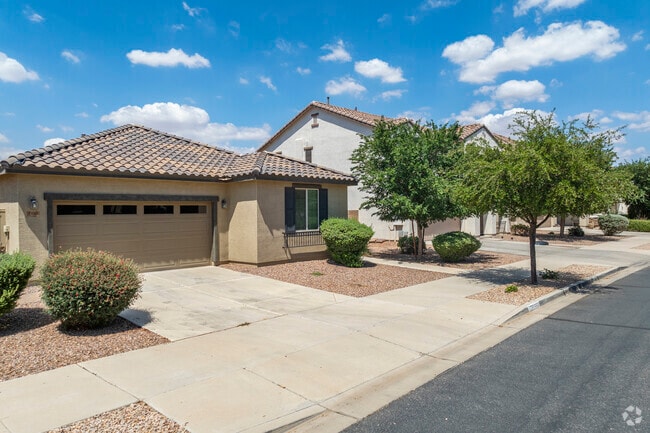 The neighborhood of Hastings Farms features homes with stucco exteriors and tile roofs, reflecting classic southwestern architecture.