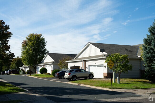 Quiet cul-de-sac in Maplewood Heights, lined with well-kept homes and shaded by mature trees on a peaceful afternoon.