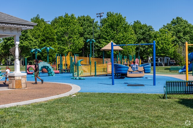 Children play at Ashley Nicole's Dream Playground on a summer day in Knoxville.