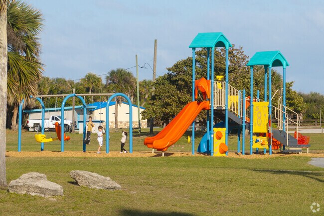 The large, colorful playground at Lori Wilson Park features a fun slide, swings, and climbing areas for kids to enjoy.