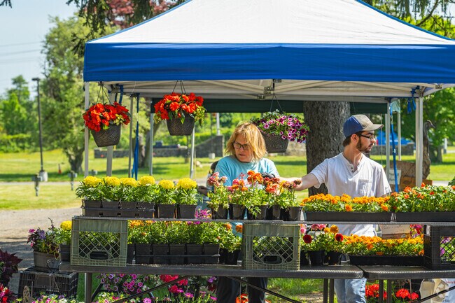 Vendors help customers find the perfect set of flowers at Glasgow Park Farmers Market.