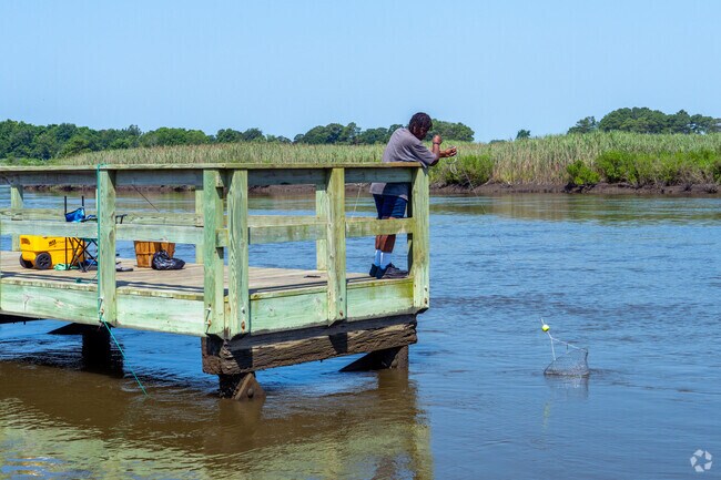 Locals enjoy fishing along Magnolia’s quiet riverbanks surrounded by lush greenery.
