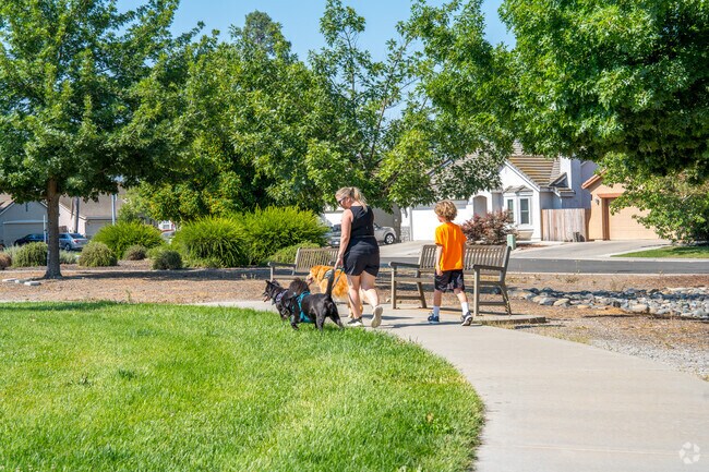 People walking their dog in Hummingbird park in the Gateway West Neighborhood.
