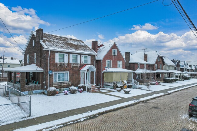 Colonial Revival and foursquare homes sit snuggly along sidewalk-lined streets.