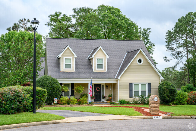 Traditional Style Homes in Sheldon have a driveway and garages with forestry in the rear.