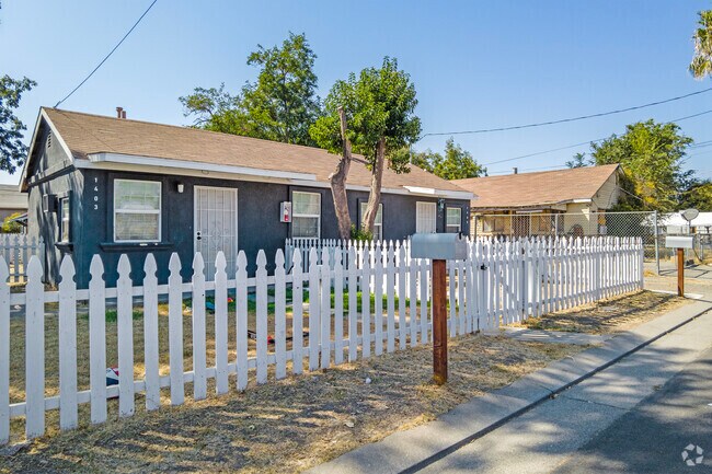 A white picket fence lines the yard of a home in the August area.